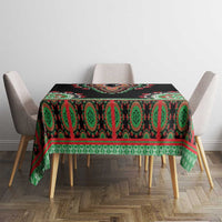 Black dashiki tablecloth on rectangular table with green/red border pattern
