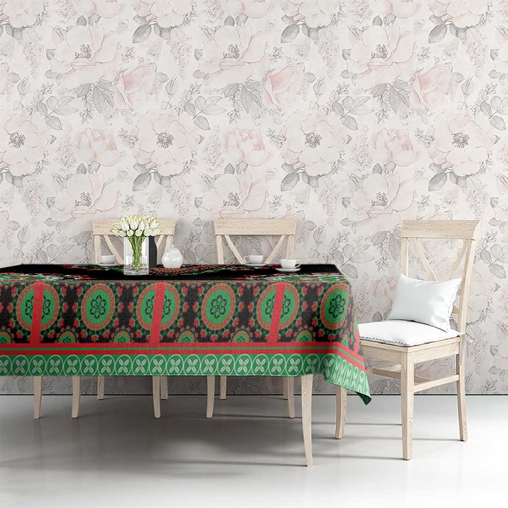 Black tablecloth with green/red medallion and stripe pattern on dining table