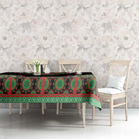 Black tablecloth with green/red medallion and stripe pattern on dining table