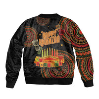 Black bomber jacket with Kwanzaa graphic, tribal pattern sleeves, ribbed cuffs and hem