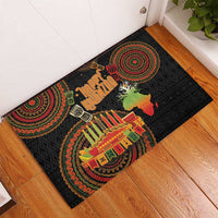 Black rubber doormat with 'Happy Kwanzaa' lettering, kinara candles, and African map graphic
