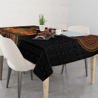 Black geometric tribal tablecloth with colorful medallion accents on a dining table