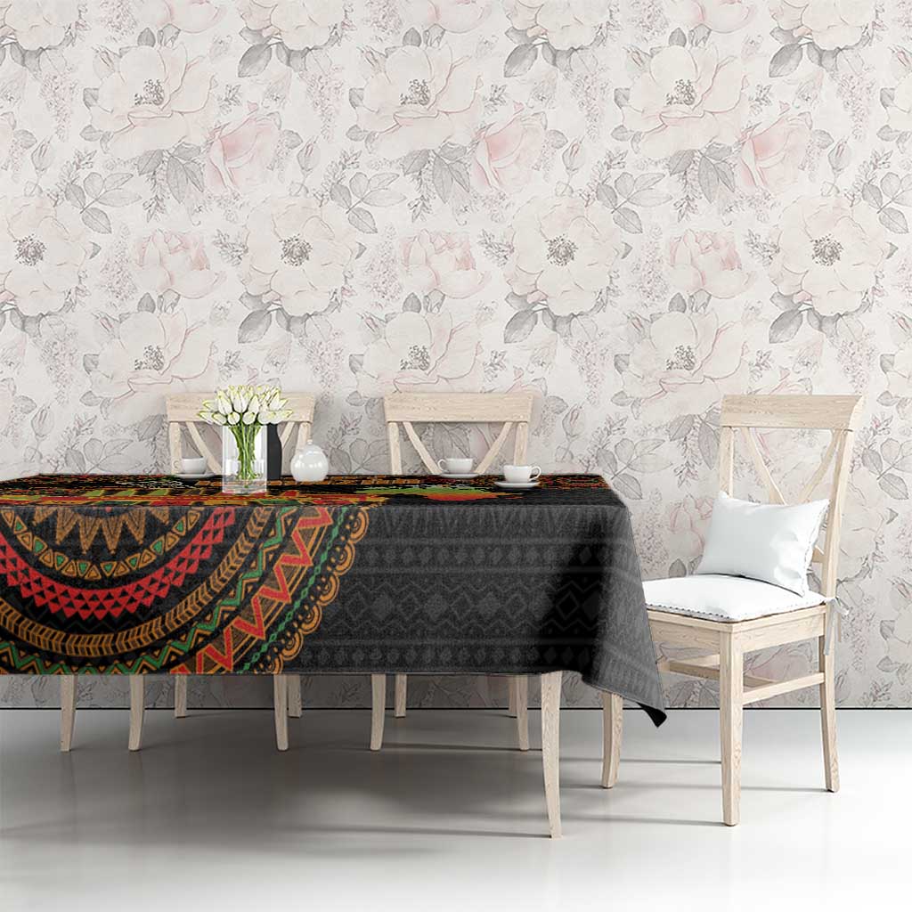 Black tribal-pattern tablecloth with colorful border on a dining table with chairs