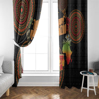 Black window curtain panels with circular tribal motifs and colorful Kwanzaa candles