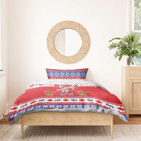 Red Christmas duvet with Santa and gingerbread figures, “Merry Christmas” text and blue border