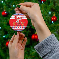 Red circular ceramic Christmas ornament with “Merry Christmas” Santa and dancing reindeer
