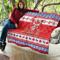 Red Christmas quilt draped over sofa with blue-and-white border, Santa and groundhog art