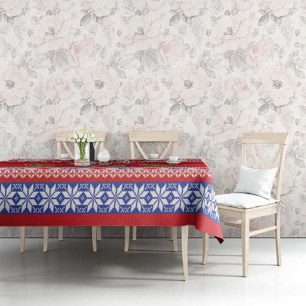 Red and blue holiday tablecloth with snowflake-knit band on dining table