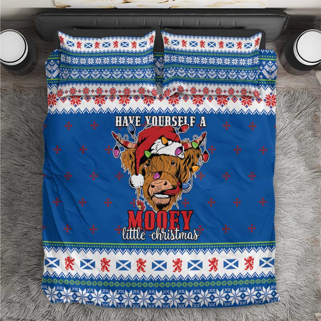 Blue Christmas bedding set with Highland cow graphic, patterned border and pillowcases
