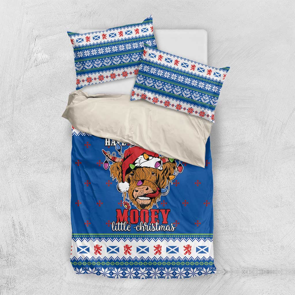 Blue Christmas bedding set with Highland cow duvet cover and two pillowcases, flat lay