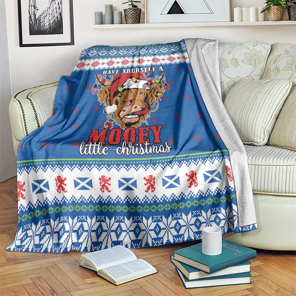 Blue Christmas blanket with Highland cow graphic and festive knit-pattern border