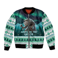 Unisex green bomber jacket with festive creature graphic, zip front, patterned sleeves