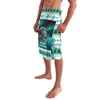 Green Christmas sarong with Gryla graphic and festive landscape border
