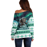 Women’s green off-shoulder Christmas sweater with back Gryla print and fair-isle stripes