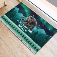 Holiday rubber doormat with dark green landscape print, dotted stars, and border rows