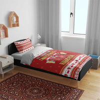 Red Christmas bedding set on bed with duvet and two pillowcases, kielbasa holiday design