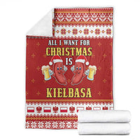 Red Christmas blanket with kielbasa cartoon, folded and stacked with white towels