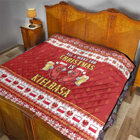 Red Christmas quilt laid over bed with large sausage graphic and holiday text
