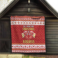 Red Christmas quilt hanging on wall with diamond quilting and sausage characters