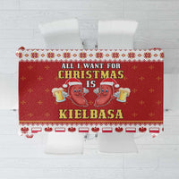 Red holiday tablecloth with “CHRISTMAS” text, kielbasa cartoon icons, white border