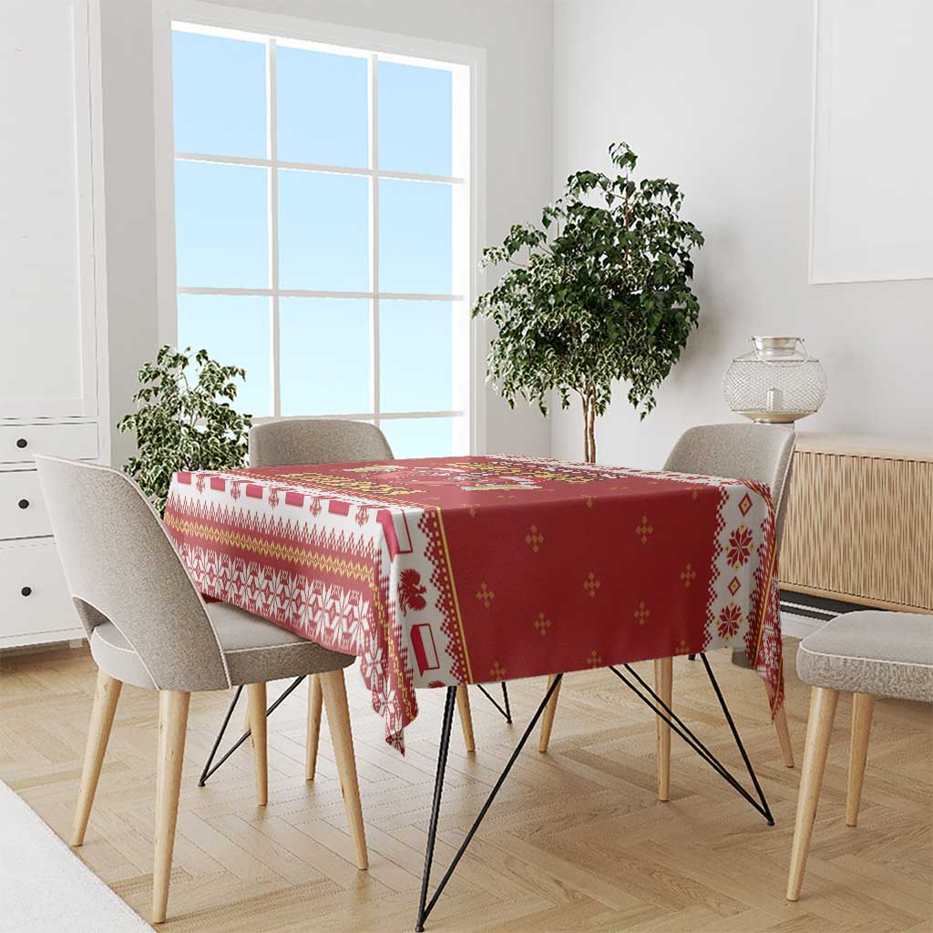 Red tablecloth with festive border and repeating geometric motifs in white