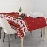 Red tablecloth with patterned band and snowflake motifs, draped over table