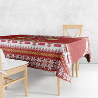 Red tablecloth with striped patterned edge and repeating holiday icons