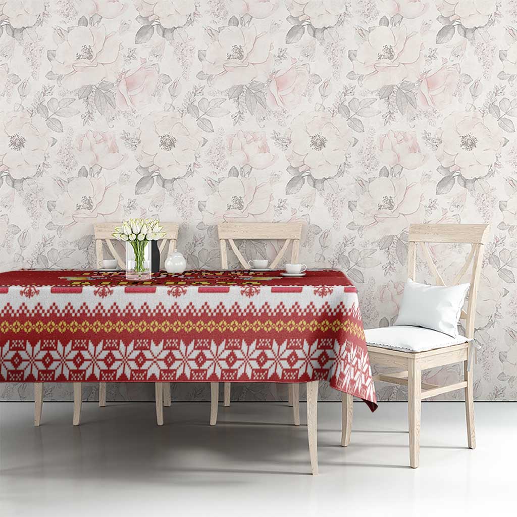 Red patterned tablecloth with repeating festive icons, draped across dining table