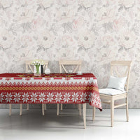 Red patterned tablecloth with repeating festive icons, draped across dining table