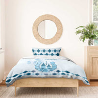 Blue and white duvet cover with Kentucky Derby graphic and diamond border on a bed