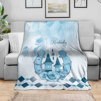 Blue Kentucky Derby blanket draped on sofa, showing horses, roses and a diamond border