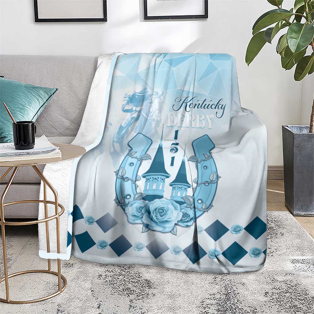 Blue horse-themed blanket on rug with Kentucky Derby logo, roses and dark-blue diamond pattern