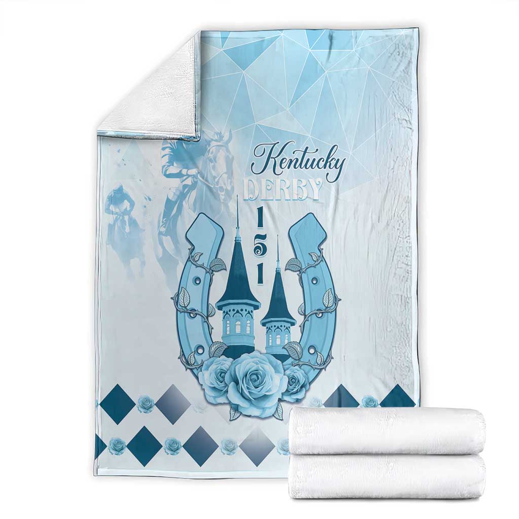 Blue horse-themed blanket with Kentucky Derby text, castle and roses, folded with rolled accents
