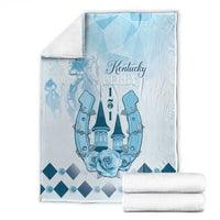 Blue horse-themed blanket with Kentucky Derby text, castle and roses, folded with rolled accents