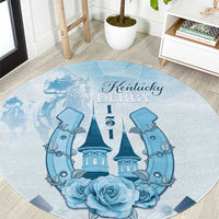Blue round carpet with Kentucky Derby script, central castle, flanking horses, and roses