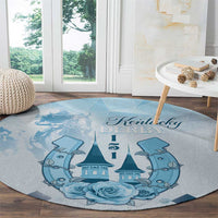 Blue round carpet with Kentucky Derby script, castle and horses graphic, and blue roses