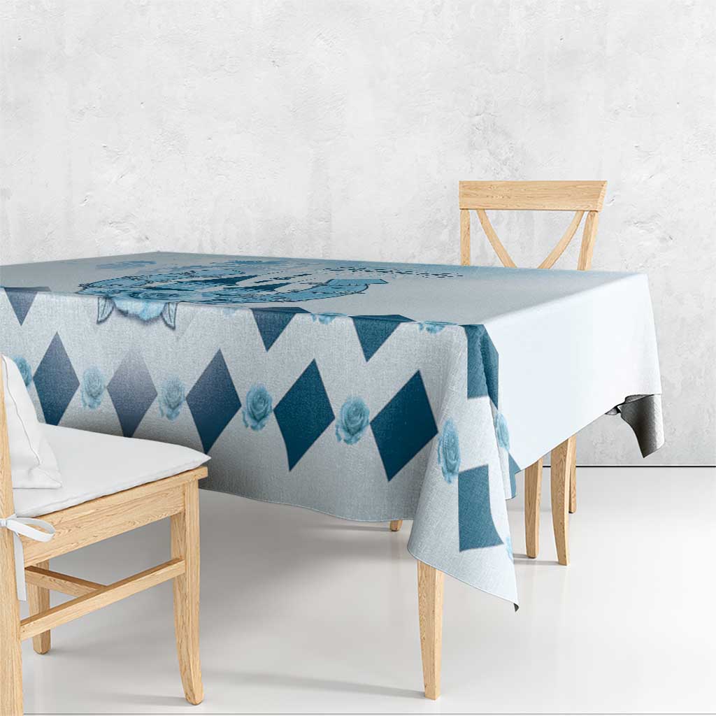 Blue diamond-pattern tablecloth with long overhang on dining table