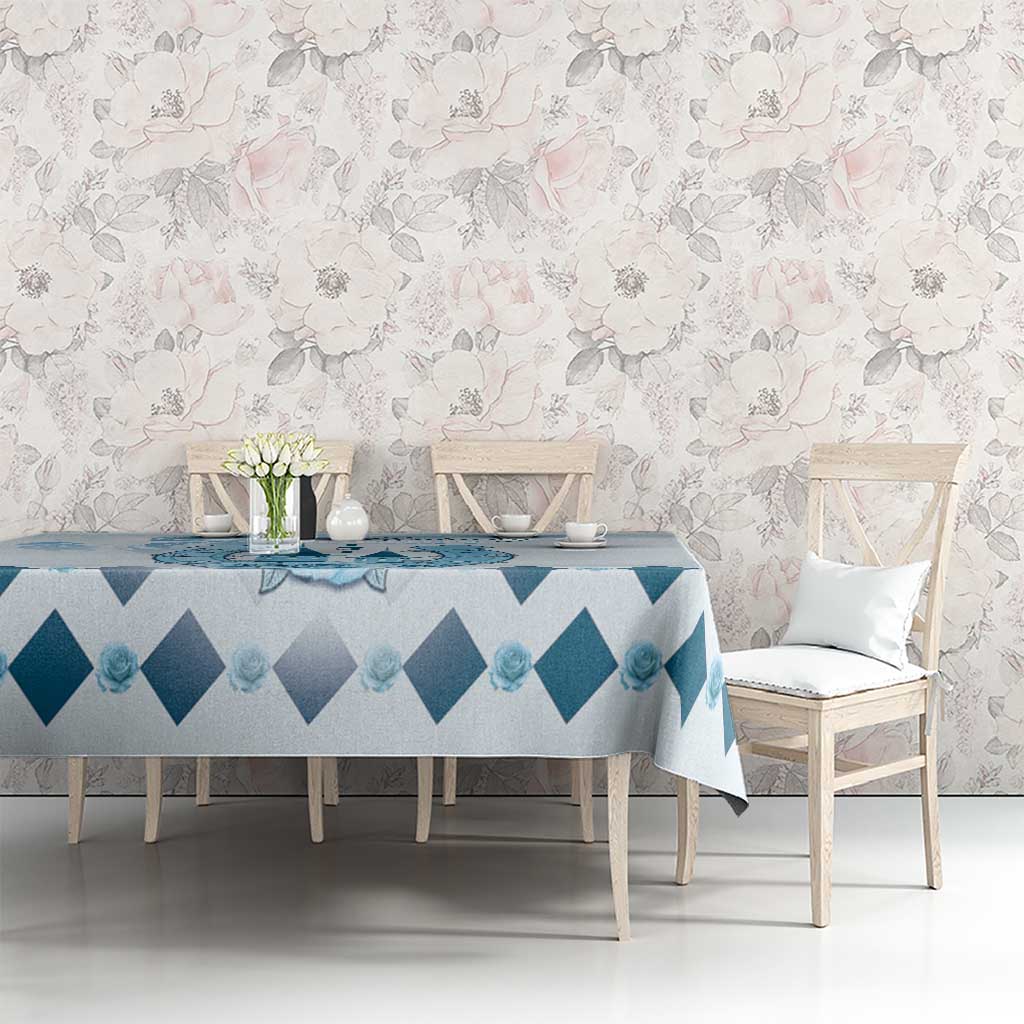 Blue and white diamond tablecloth with light floral accents on dining table