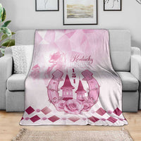 Pink and white Kentucky Derby throw blanket draped over sofa with roses-and-horses graphic