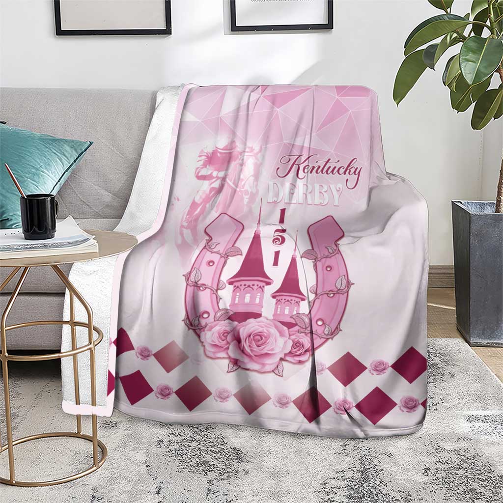 Pink Kentucky Derby throw blanket with roses and diamond pattern, displayed on sofa seat