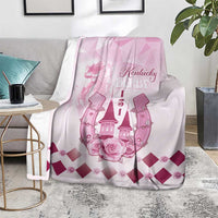 Pink Kentucky Derby throw blanket with roses and diamond pattern, displayed on sofa seat