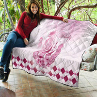Pink and white Kentucky quilt held on sofa, with diamond stitching and floral horse art