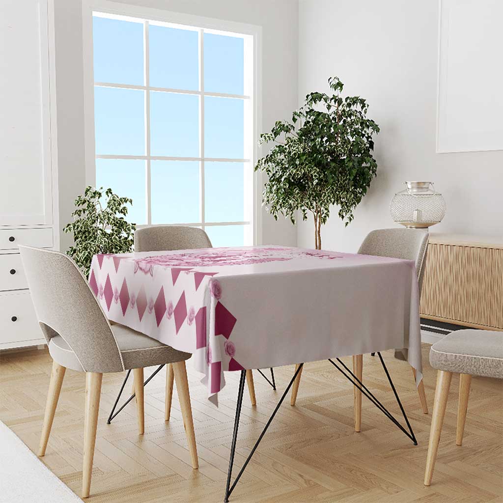 Pink and white tablecloth with repeating diamond pattern and small rose details on table