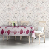 Pink and white diamond-pattern tablecloth with floral motif panel across table surface