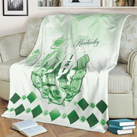 Green and white throw blanket draped on armchair with Kentucky Derby emblem and diamond pattern.