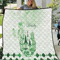 White quilt close-up with green Kentucky horse crest and diamond-quilt pattern
