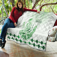 White quilt with green Kentucky horse crest, diamond quilt stitching, and check border
