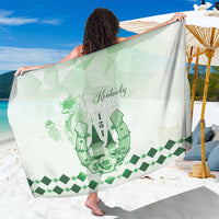Green graphic sarong with checkered horses motif, draped over shoulders