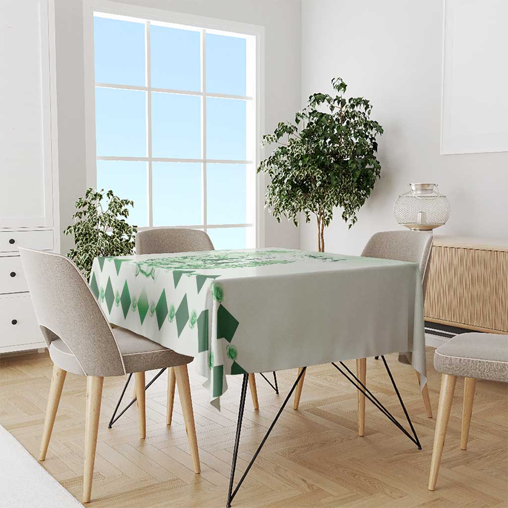 Green diamond-pattern tablecloth with rose motifs on dining table