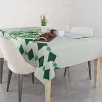 Green tablecloth with repeating diamond print and rose details on dining table
